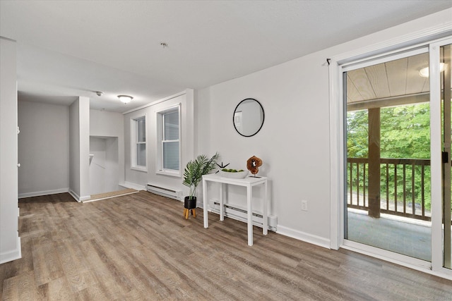 34 Pleasant St Unit 6, Plainfield, CT 06374 - foyer featuring baseboard heating, wood finished floors, and baseboards