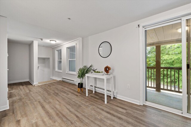 34 Pleasant St Unit 6, Plainfield, CT 06374 - entryway with a baseboard radiator, wood finished floors, and baseboards