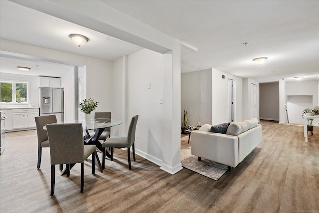 34 Pleasant St Unit 6, Plainfield, CT 06374 - dining area with light wood-style flooring and baseboards