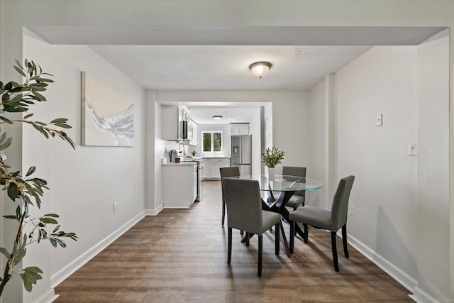 34 Pleasant St Unit 6, Plainfield, CT 06374 - dining space featuring dark wood-type flooring and baseboards
