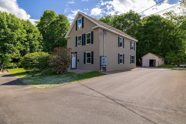 34 Pleasant St Unit 6, Plainfield, CT 06374 - view of front of house with an outdoor structure and view of wooded area