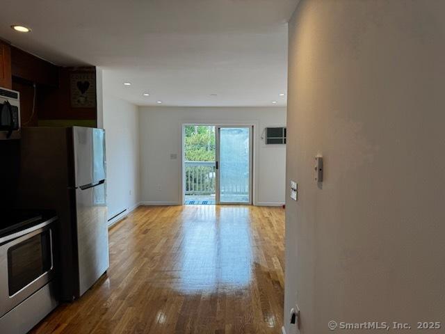 133 Main St Apt 4, Norwalk, CT 06851 - kitchen featuring stainless steel appliances, a baseboard radiator, wood finished floors, and recessed lighting