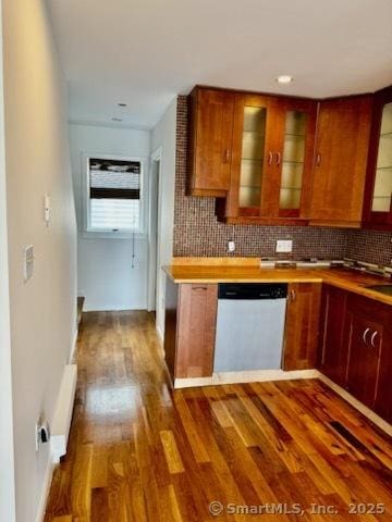 133 Main St Apt 4, Norwalk, CT 06851 - kitchen featuring dishwashing machine, dark wood-style flooring, backsplash, glass insert cabinets, and light countertops