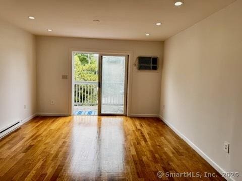 133 Main St Apt 4, Norwalk, CT 06851 - empty room with wood finished floors, recessed lighting, baseboard heating, and a wall mounted AC