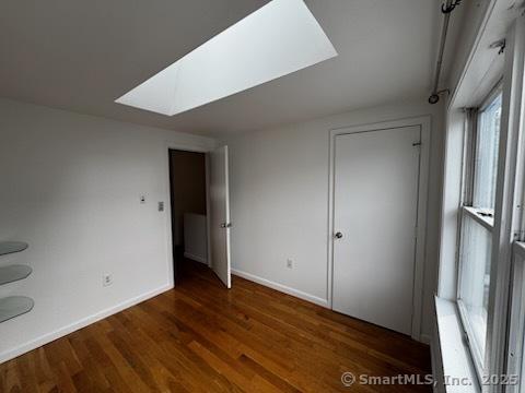 133 Main St Apt 4, Norwalk, CT 06851 - unfurnished bedroom with a skylight and wood finished floors