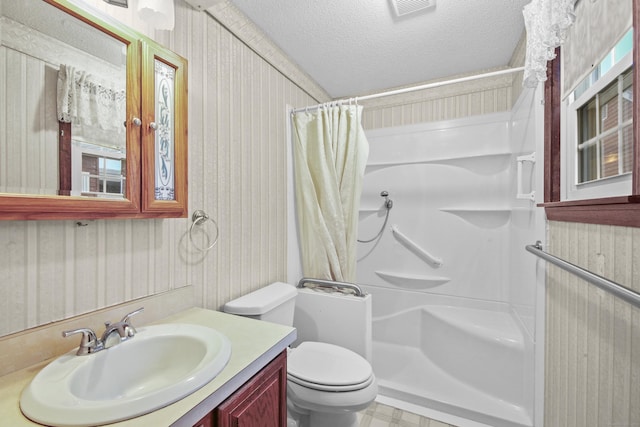 415 Lady Bug Ln Unit 415, Vernon, CT 06066 - bathroom with a shower with shower curtain, vanity, toilet, a textured ceiling, and wallpapered walls