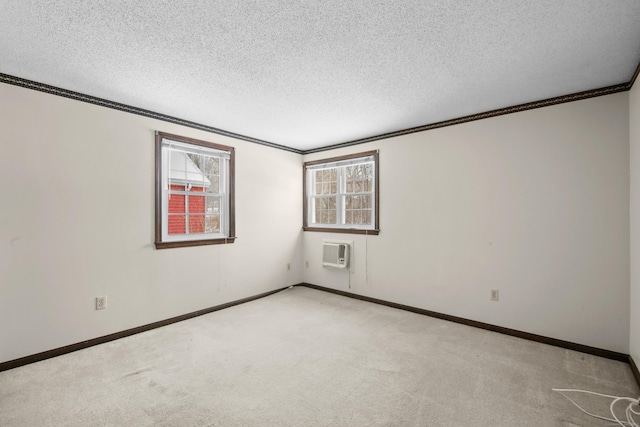 415 Lady Bug Ln Unit 415, Vernon, CT 06066 - spare room with crown molding, a textured ceiling, carpet floors, baseboards, and a wall unit AC