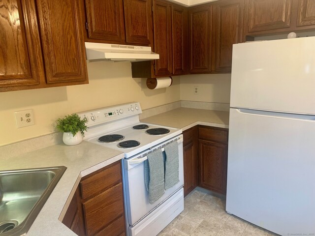 415 Lady Bug Ln Unit 415, Vernon, CT 06066 - kitchen with white appliances, under cabinet range hood, light countertops, and a sink
