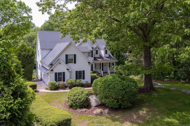 12 Stanton Ct, Madison, CT 06443 - view of front facade featuring a front yard, covered porch, a garage, and a shingled roof