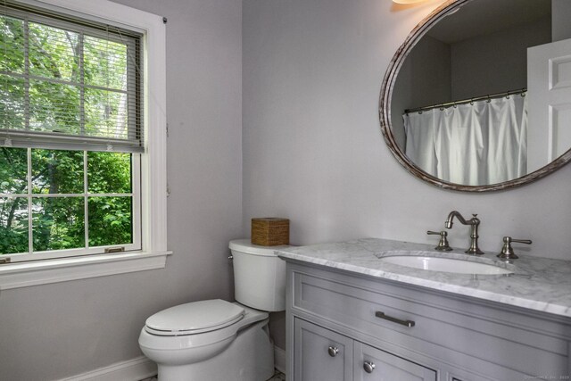 12 Stanton Ct, Madison, CT 06443 - full bathroom with baseboards, vanity, and toilet