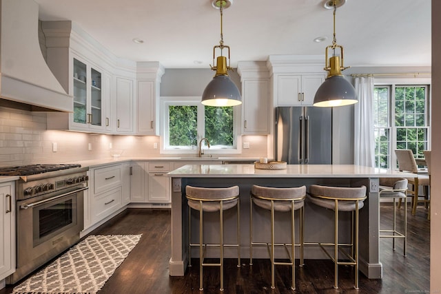 12 Stanton Ct, Madison, CT 06443 - kitchen featuring high quality appliances, wall chimney exhaust hood, light countertops, a sink, and recessed lighting