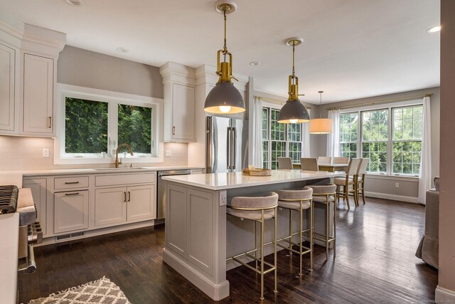 12 Stanton Ct, Madison, CT 06443 - kitchen featuring appliances with stainless steel finishes, a sink, decorative backsplash, dark wood-style flooring, and recessed lighting