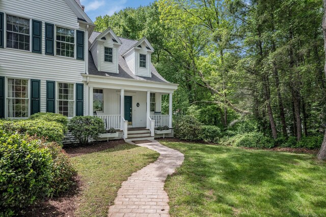 12 Stanton Ct, Madison, CT 06443 - view of front of house featuring a porch, a front yard, and roof with shingles
