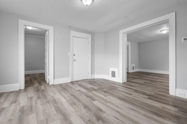 108 Highland Ave, Waterbury, CT 06708 - spare room with wood finished floors, a paneled ceiling, and baseboards