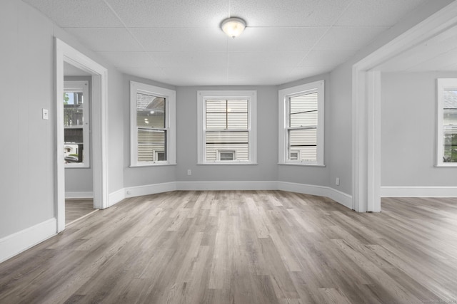 108 Highland Ave, Waterbury, CT 06708 - unfurnished room with wood finished floors, a drop ceiling, and baseboards
