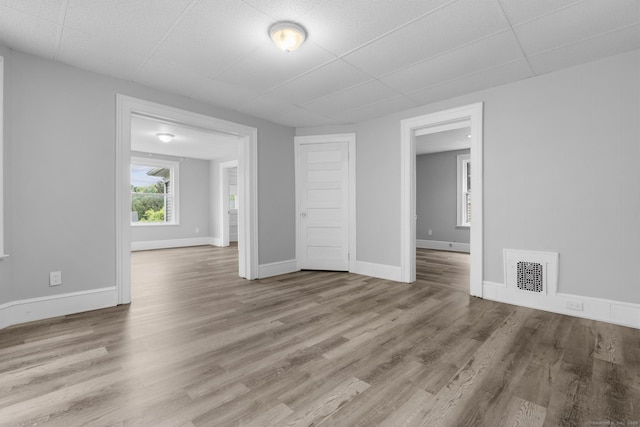 108 Highland Ave, Waterbury, CT 06708 - empty room with wood finished floors, baseboards, and a paneled ceiling