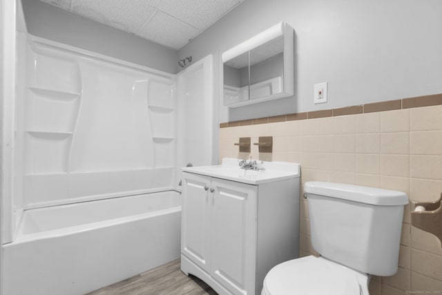 108 Highland Ave, Waterbury, CT 06708 - full bath with vanity, toilet, tile walls, shower / bath combination, and a wainscoted wall