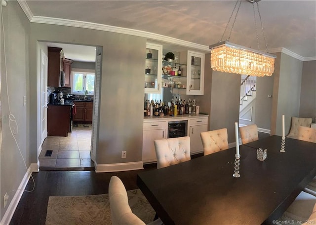 665 W Main St, West Haven, CT 06516 - dining space featuring a dry bar, stairs, baseboards, a chandelier, and beverage cooler