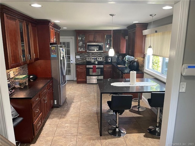 665 W Main St, West Haven, CT 06516 - kitchen featuring stainless steel appliances, dark countertops, backsplash, pendant lighting, and glass insert cabinets
