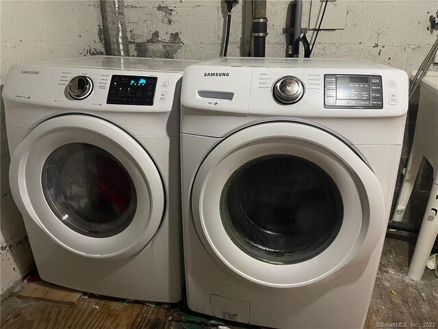 665 W Main St, West Haven, CT 06516 - laundry area with separate washer and dryer and concrete block wall