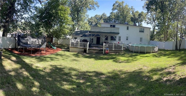 665 W Main St, West Haven, CT 06516 - rear view of property with a trampoline and a deck