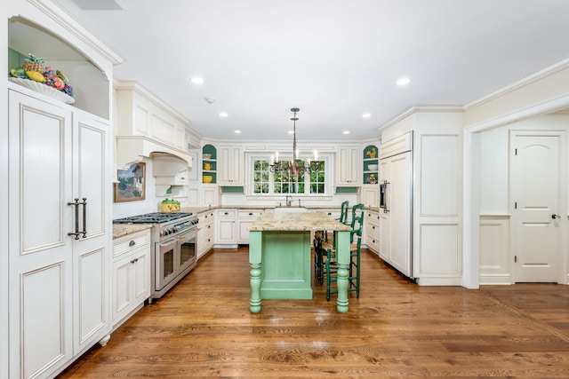 37 Salisbury Rd, Darien, CT 06820 - kitchen with high end appliances, open shelves, a sink, a breakfast bar area, and recessed lighting