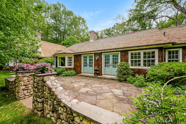 37 Salisbury Rd, Darien, CT 06820 - back of house featuring french doors, a chimney, and a patio area