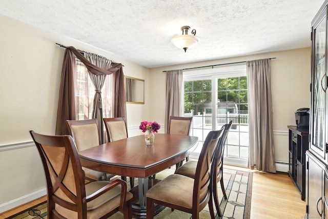 5 Crabapple Rd, Windsor, CT 06095 - dining space with light wood-style flooring, a textured ceiling, baseboard heating, and baseboards