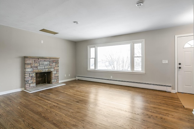 24 Manning St, New Fairfield, CT 06812 - unfurnished living room featuring a baseboard heating unit, wood finished floors, and baseboards
