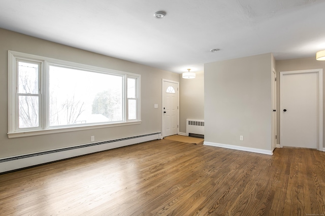 24 Manning St, New Fairfield, CT 06812 - entryway featuring radiator heating unit, baseboard heating, wood finished floors, and healthy amount of natural light