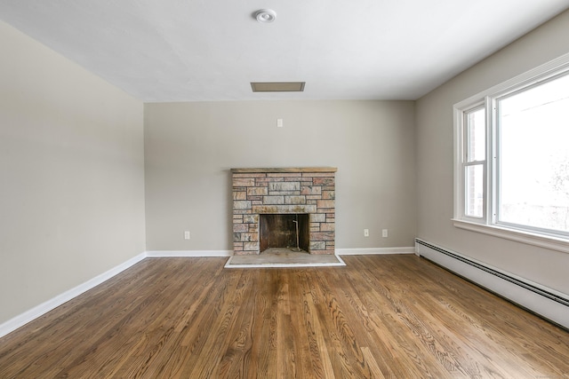 24 Manning St, New Fairfield, CT 06812 - unfurnished living room with a baseboard heating unit, wood finished floors, baseboards, and a fireplace