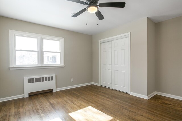24 Manning St, New Fairfield, CT 06812 - unfurnished bedroom featuring radiator, baseboards, a closet, wood finished floors, and a ceiling fan