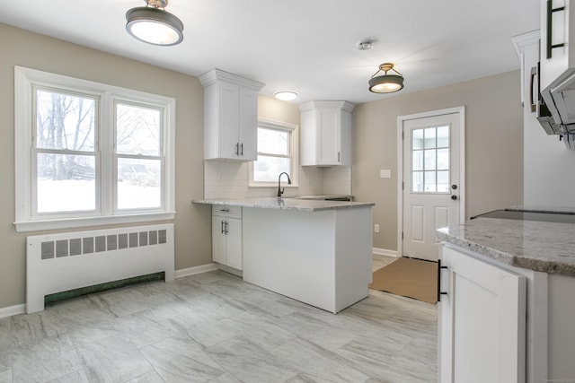 24 Manning St, New Fairfield, CT 06812 - kitchen featuring radiator, white cabinetry, light stone counters, and baseboards