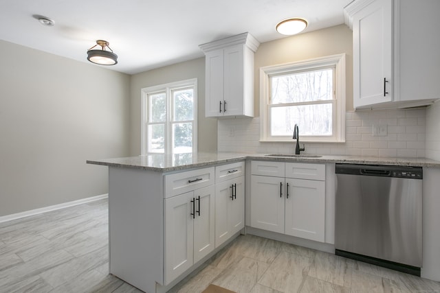 24 Manning St, New Fairfield, CT 06812 - kitchen with stainless steel dishwasher, a sink, a peninsula, and white cabinetry