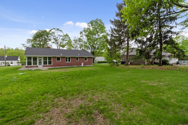 24 Manning St, New Fairfield, CT 06812 - back of house featuring a sunroom, a yard, and a chimney