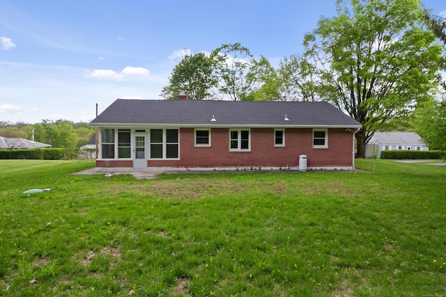 24 Manning St, New Fairfield, CT 06812 - rear view of house with brick siding, a sunroom, a yard, and a chimney