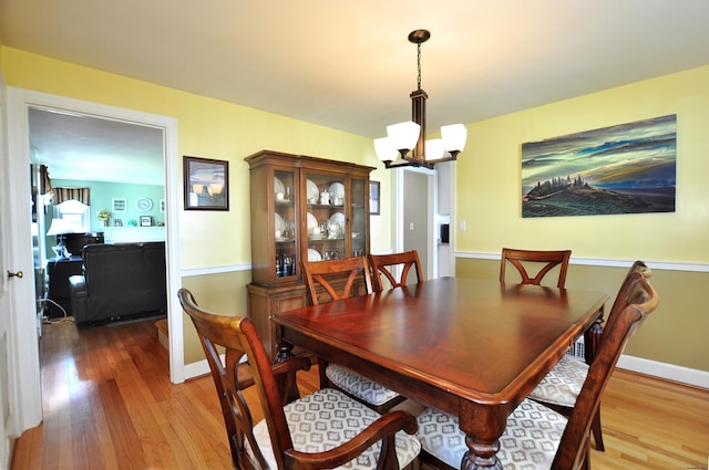 89 Bigelow St, Manchester, CT 06040 - dining area with a chandelier, wood finished floors, and baseboards