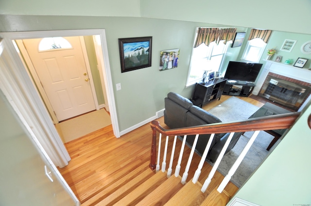 89 Bigelow St, Manchester, CT 06040 - living room with light wood finished floors, a fireplace, baseboards, and a desk