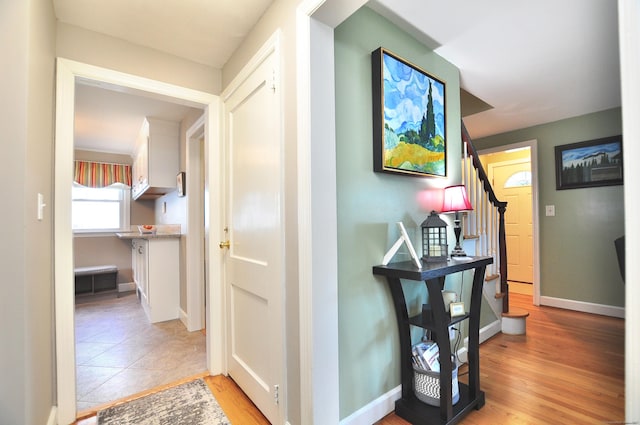 89 Bigelow St, Manchester, CT 06040 - corridor featuring stairs, light wood-style flooring, and baseboards