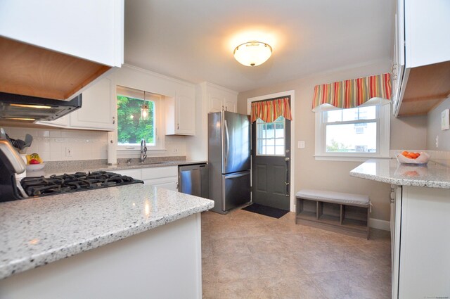 89 Bigelow St, Manchester, CT 06040 - kitchen featuring stainless steel appliances, a sink, white cabinets, and light stone counters