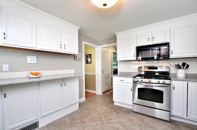 89 Bigelow St, Manchester, CT 06040 - kitchen featuring black microwave, stainless steel gas range, backsplash, and white cabinetry