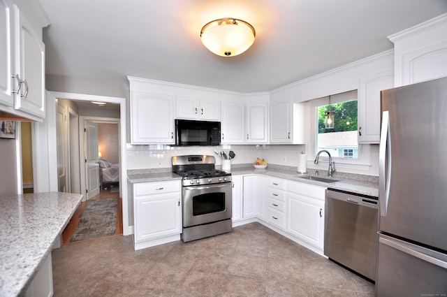 89 Bigelow St, Manchester, CT 06040 - kitchen featuring stainless steel appliances, a sink, tasteful backsplash, white cabinets, and light stone counters