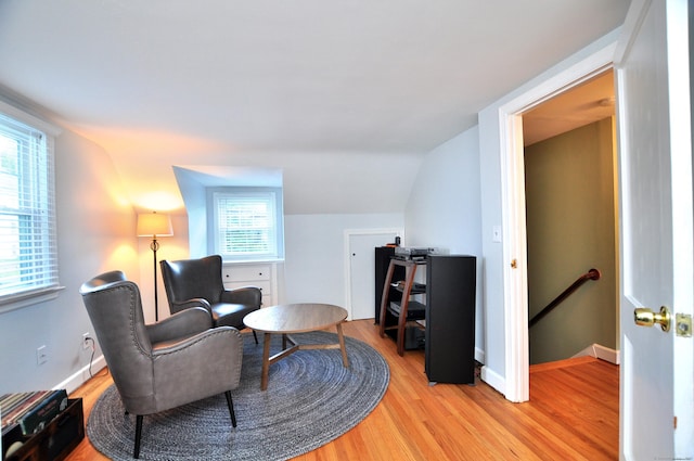 89 Bigelow St, Manchester, CT 06040 - living area featuring an upstairs landing, light wood-type flooring, lofted ceiling, and baseboards
