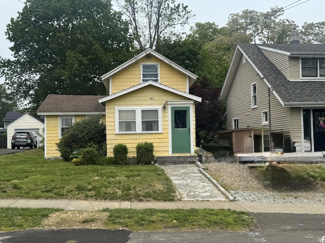 1182 N Ave, Stratford, CT 06614 - view of front of house with a shingled roof and a front lawn