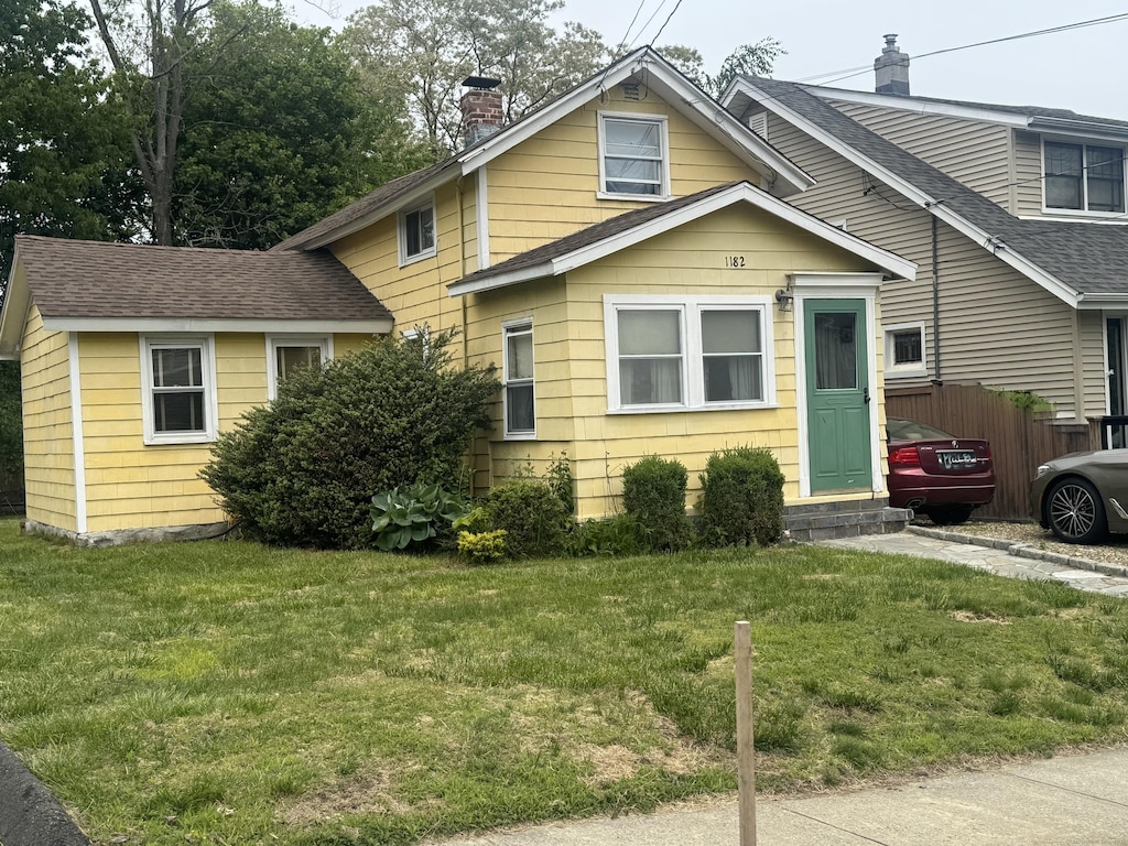 1182 N Ave, Stratford, CT 06614 - view of front of property with a chimney, entry steps, and roof with shingles