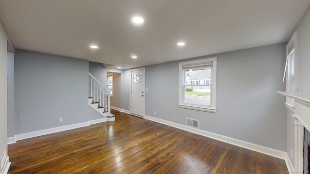 77 Hemlock St, Manchester, CT 06040 - foyer entrance with stairs, dark wood-type flooring, recessed lighting, baseboards, and a fireplace