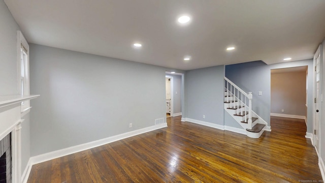 77 Hemlock St, Manchester, CT 06040 - unfurnished living room featuring stairs, recessed lighting, dark wood-type flooring, baseboards, and a fireplace