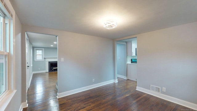 77 Hemlock St, Manchester, CT 06040 - empty room featuring a fireplace with flush hearth, dark wood finished floors, and baseboards