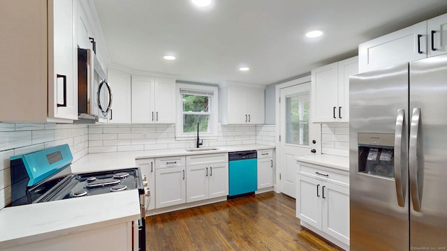 77 Hemlock St, Manchester, CT 06040 - kitchen featuring stainless steel appliances, a sink, light countertops, backsplash, and white cabinetry