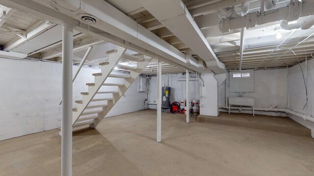 77 Hemlock St, Manchester, CT 06040 - unfinished basement featuring stairs, water heater, electric panel, and a sink